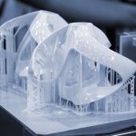 Printed models on 3D printer close-up. Objects printed on photopolymer sla 3D printer from liquid photopolymer resins on printing platform. Modern progressive additive technology. 3D printer printing